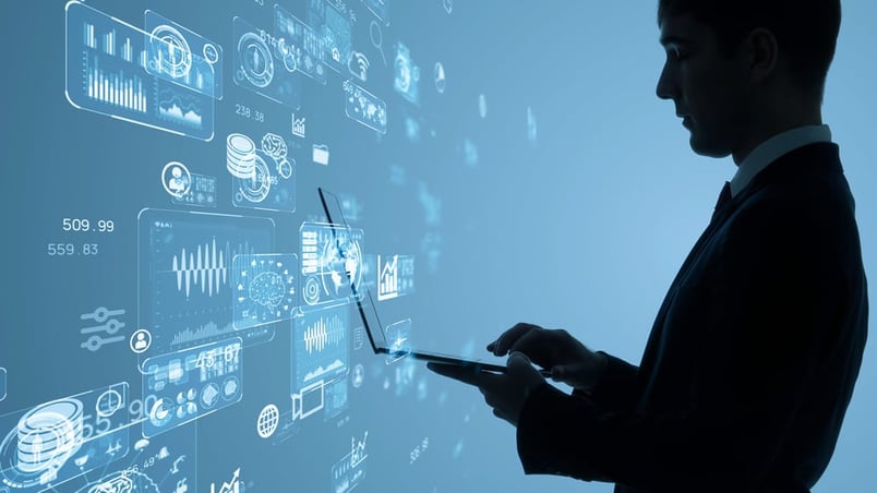 Man on laptop in front of screen ponders stages of a contract management process