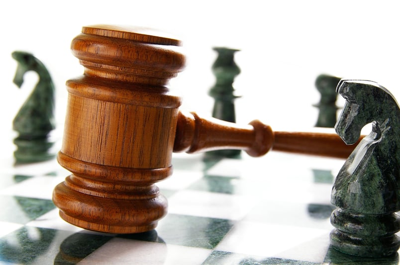 Chess board and gavel representing legal strategy, best served by AI and contracts
