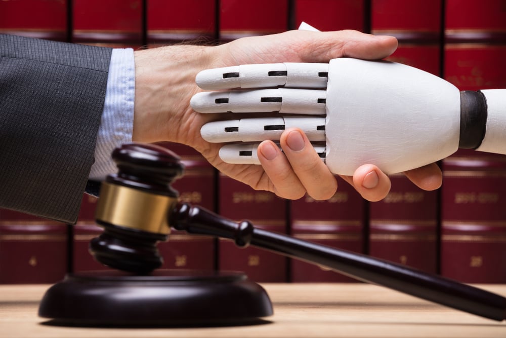 Robot representation of legal operation tool shakes hands with a lawyer.