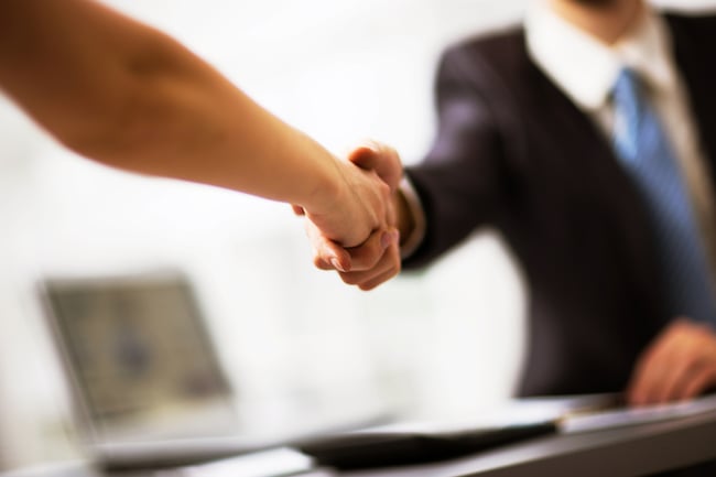  Attorney shakes hands with newly hired Director of Legal Operations